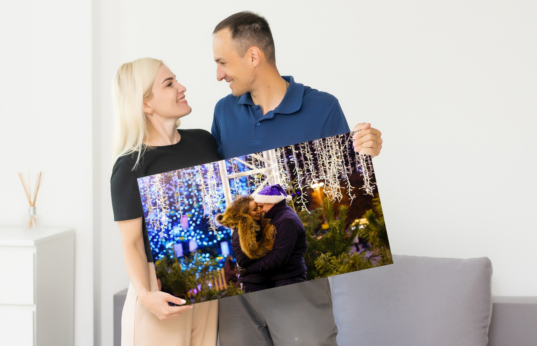 man woman holding photo canvas